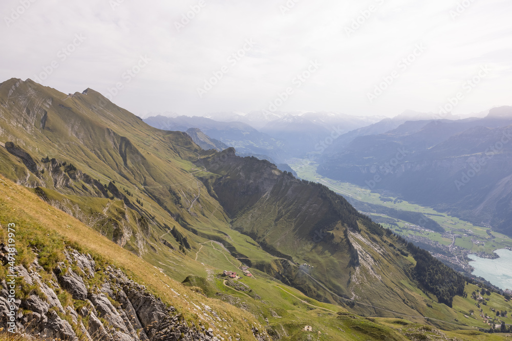 Fototapeta premium Amazing hiking day in the alps of Switzerland. Wonderful view over a beautiful lake called Brienzersee. What an amazing view.