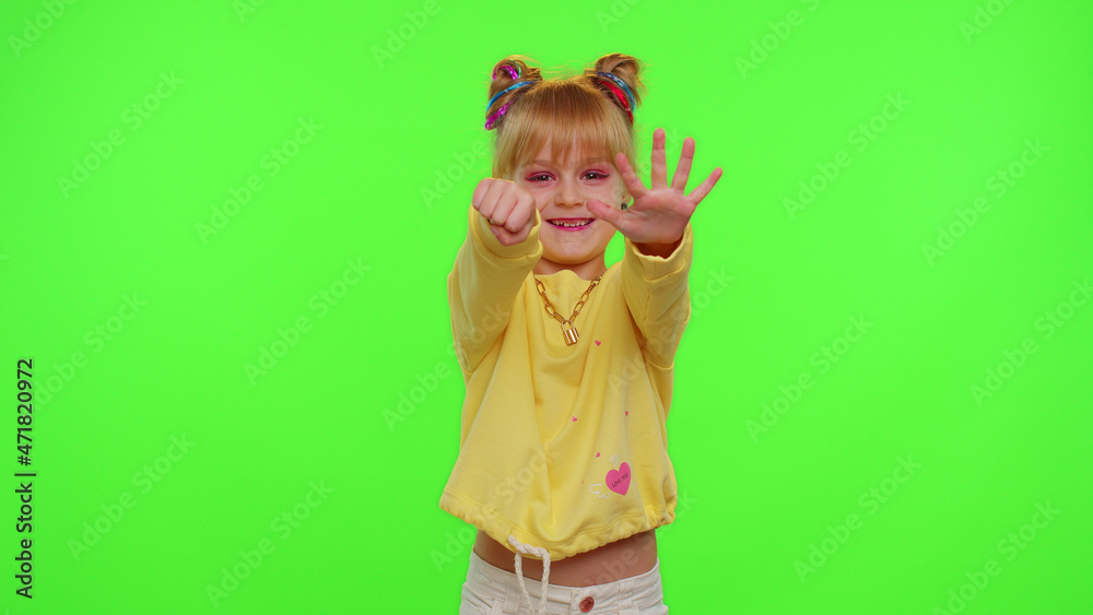 Happy little Caucasian kid girl blogger front of phone camera record video enjoy dance content on green chroma key background. Social distance coronavirus pandemic concept. Freedom active lifestyle Happy little Caucasian kid girl blogger front of phone camera record video enjoy dance content on green chroma key background. Social distance coronavirus pandemic concept. Freedom active lifestyle