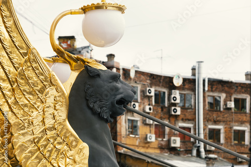 Saint Petersburg, Russia - March 2021: Sculptures of Griffin with golden wings on the Bank bridge