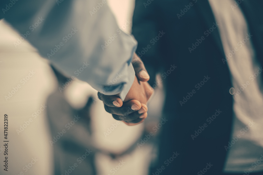 close up. strong male handshake on the office background.