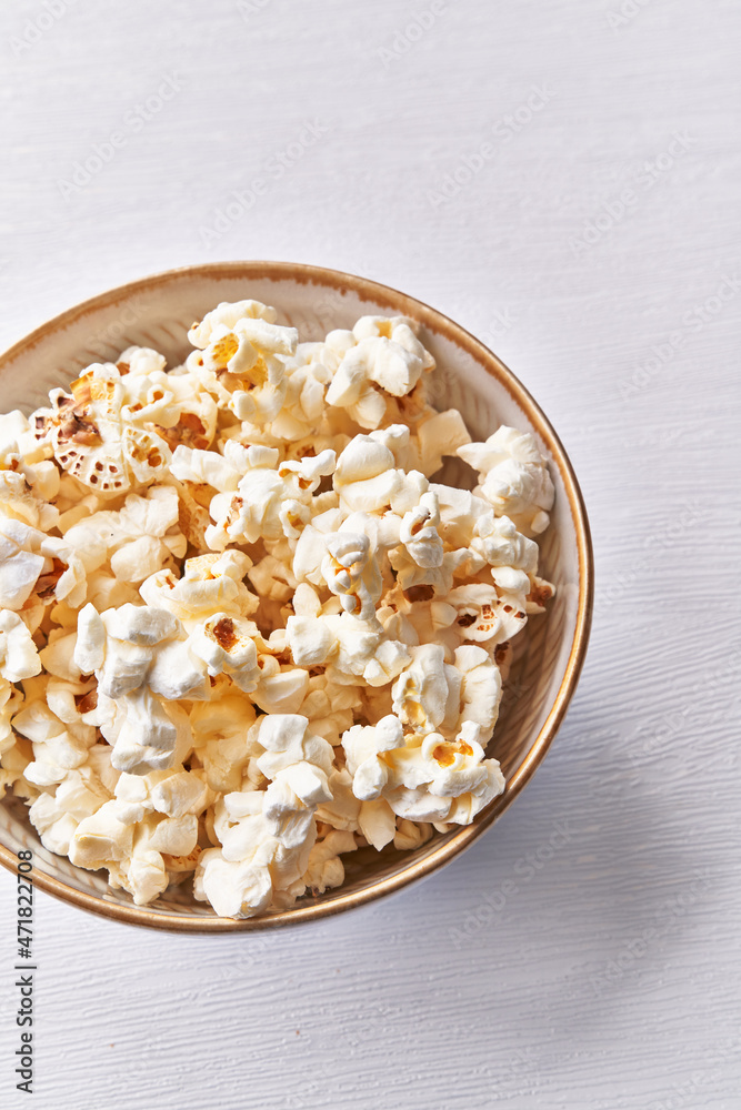 Bowl of salty popcorns isolated on a white background Bowl of salty popcorns isolated on a white background