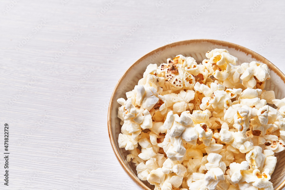Bowl of salty popcorns isolated on a white background Bowl of salty popcorns isolated on a white background