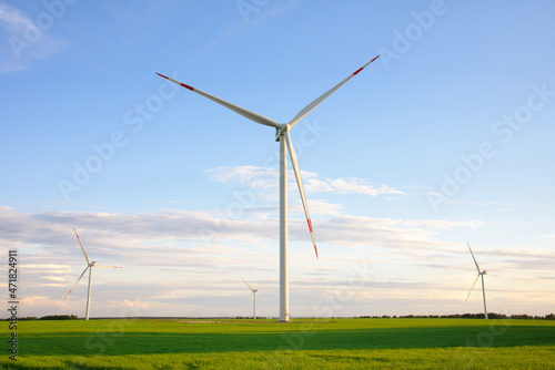 View on alternative energy windmills in a windpark in Ulyanovsk in front of a blue sky. Windmills for electric power production. © Alexei Uzinskii