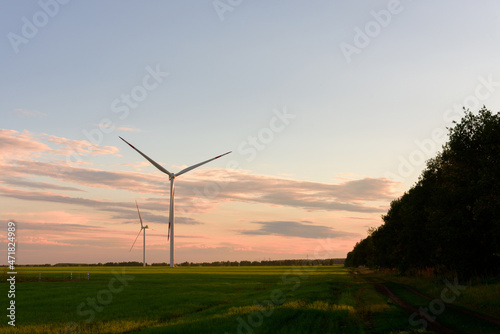 View on alternative energy windmills in a windpark in Ulyanovsk at sunset. Windmills for electric power production.