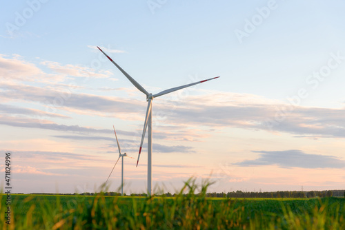 View on alternative energy windmills in a windpark in Ulyanovsk in front of a blue sky. Windmills for electric power production.