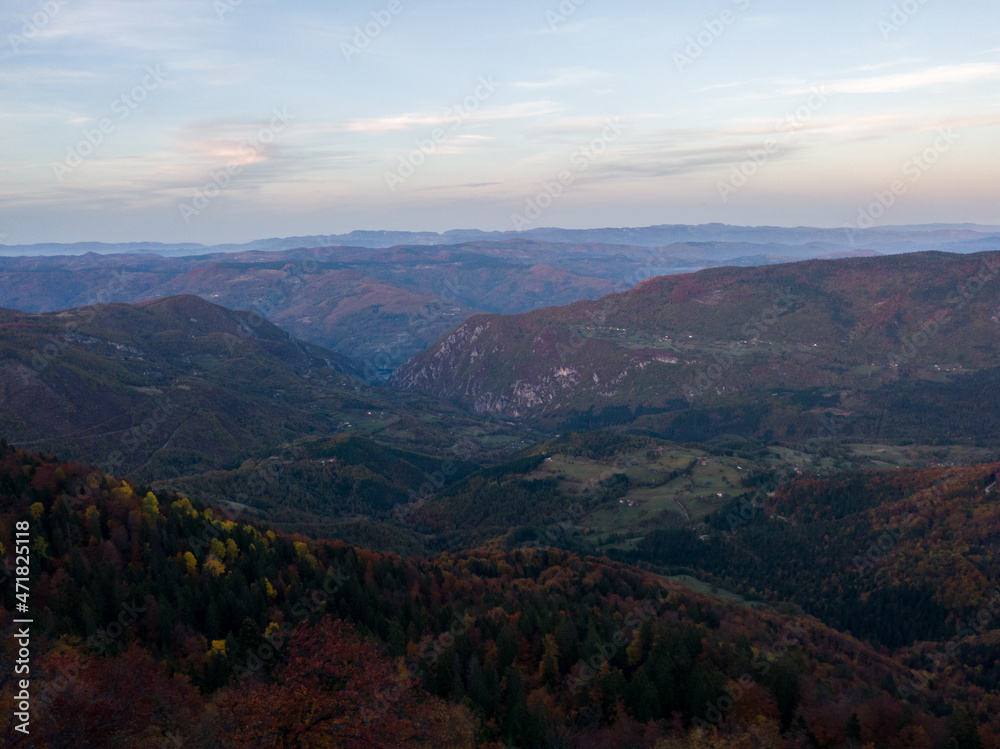 Fototapeta premium Viewpoint Sjenic in Tara National Park, view of the village in the valley and forested mountains in Serbia