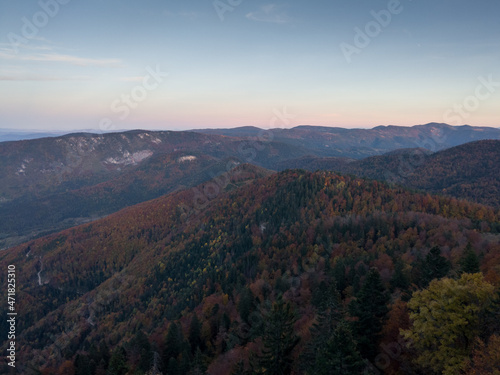 Viewpoint Sjenic in Tara National Park, view of the village in the valley and forested mountains in Serbia