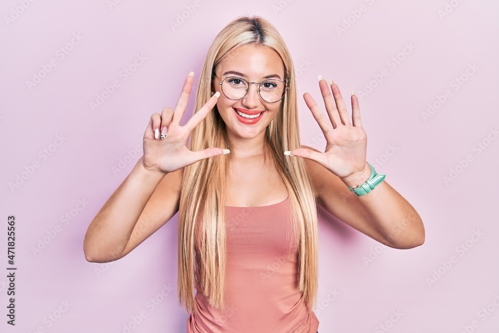 Young blonde girl wearing casual clothes showing and pointing up with fingers number eight while smiling confident and happy. Young blonde girl wearing casual clothes showing and pointing up with fingers number eight while smiling confident and happy.