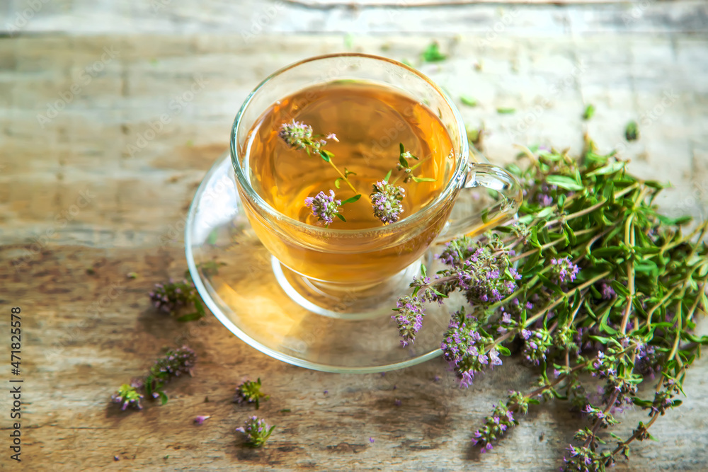 Thyme tea in a transparent cup. Selective focus. Thyme tea in a transparent cup. Selective focus.