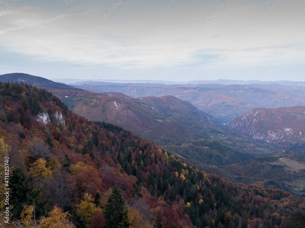 Viewpoint Sjenic in Tara National Park, view of the village in the valley and forested mountains in Serbia