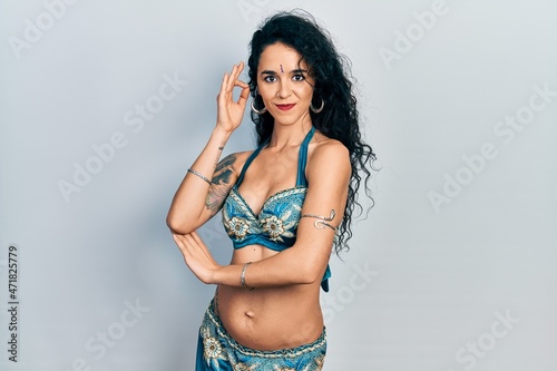 Young indian woman wearing traditional belly dancer costume. Dancing exotic oriental dance with body and hands © Krakenimages.com