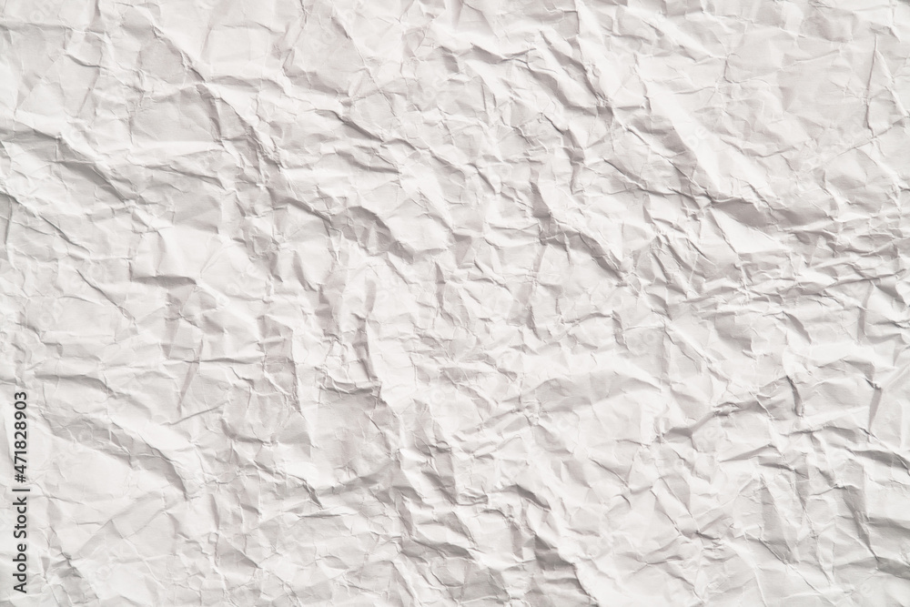 Fototapeta premium White crumpled paper texture with wrinkles. Damaged and torn sheet