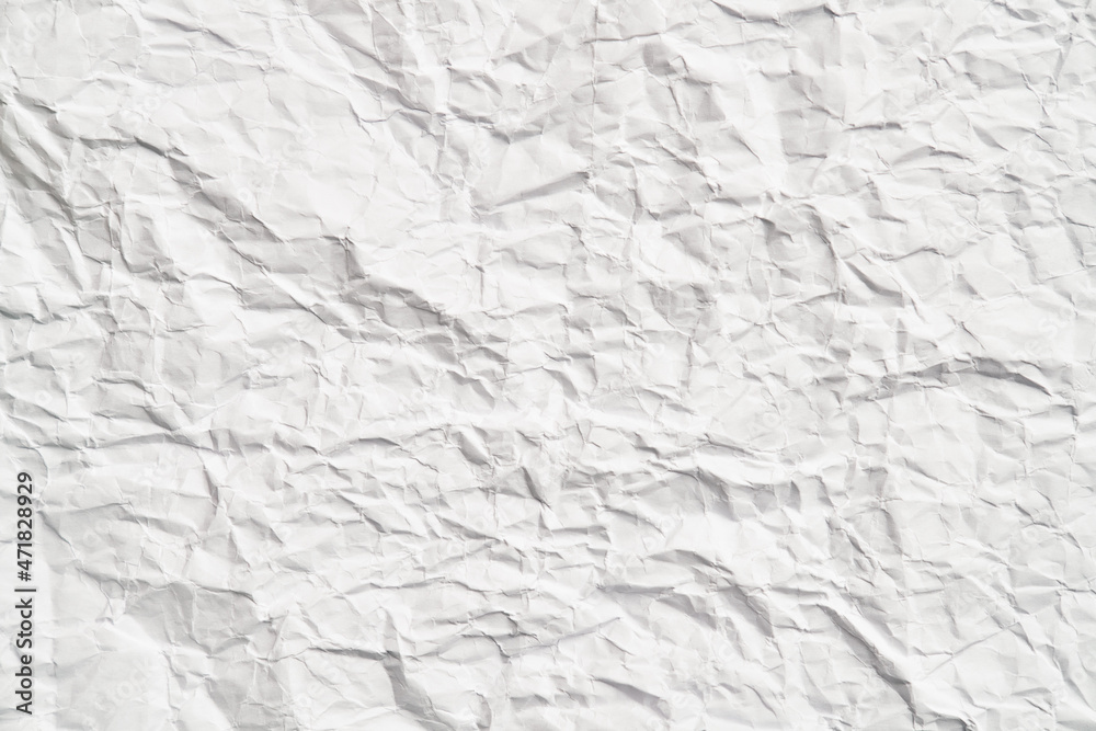 White crumpled paper texture with wrinkles. Damaged and torn sheet