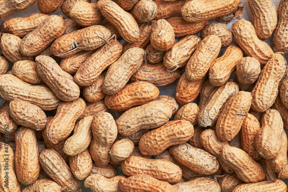 Healthy roasted unpeeled peanuts. Brown nuts texture Healthy roasted unpeeled peanuts. Brown nuts texture