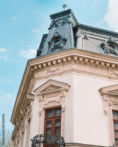 Old building from Bucharest with beautiful architecture and balcony, vibrant sky