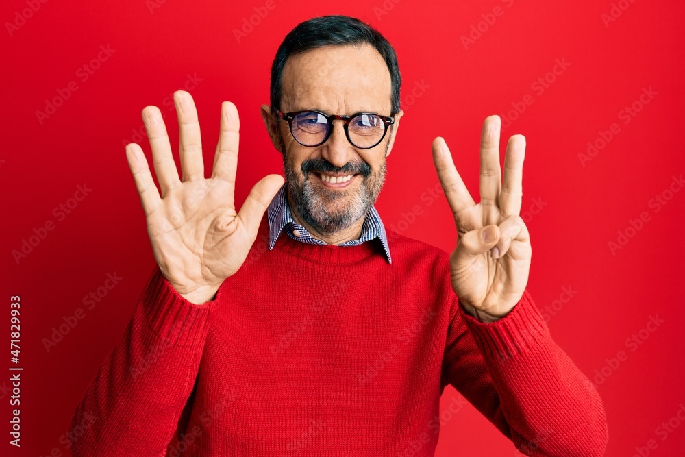 Middle age hispanic man wearing casual clothes and glasses showing and pointing up with fingers number eight while smiling confident and happy. Middle age hispanic man wearing casual clothes and glasses showing and pointing up with fingers number eight while smiling confident and happy.