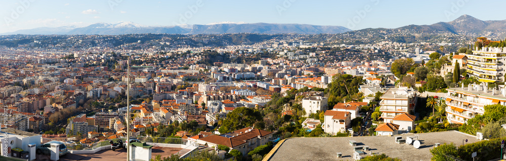 Panoramic view of Nice residential districts against backdrop of Alps in sunny day, France