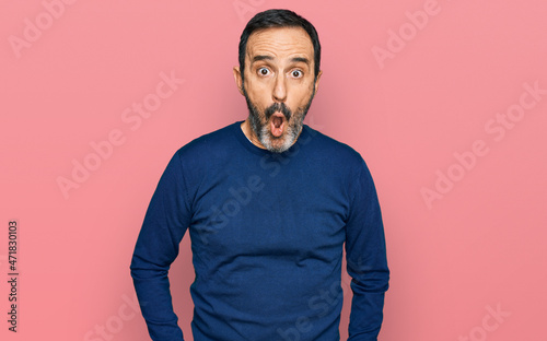 Middle age hispanic man wearing casual clothes afraid and shocked with surprise expression, fear and excited face.