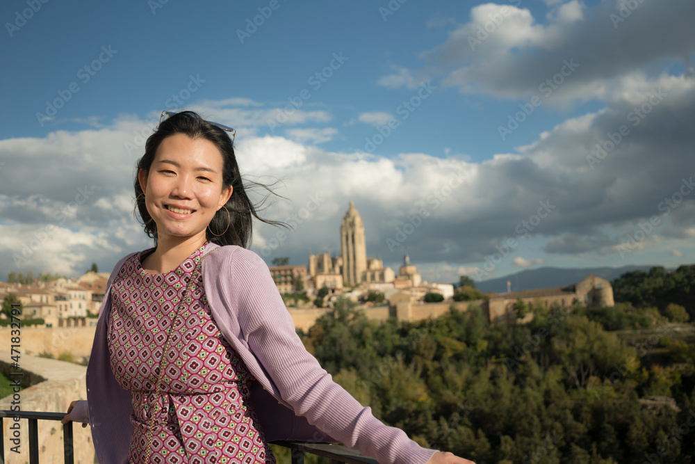 Young Asian woman outdoors lifestyle portrait -  happy and beautiful Chinese girl enjoying old town panorama from viewpoint during holiday travel in Europe smiling cheerful