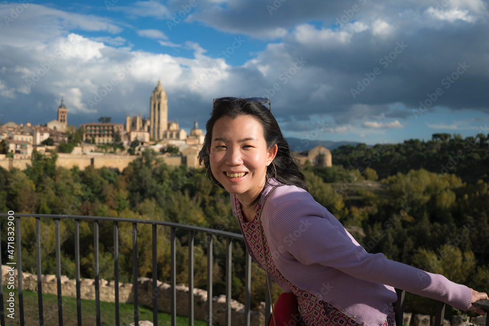 Young Asian woman outdoors lifestyle portrait -  happy and beautiful Japanese girl enjoying old town panorama from viewpoint during holiday travel in Europe smiling cheerful