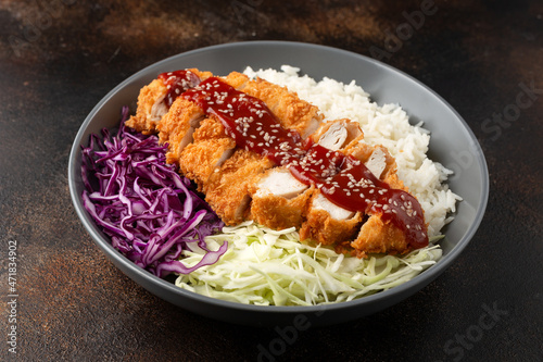 Crispy Katsu chicken with sauce, rice and cabbage. photo