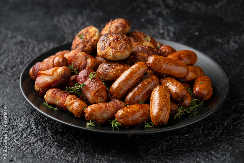 Pigs in Blankets, cocktail sausages and meatballs on plate. Party food Pigs in Blankets, cocktail sausages and meatballs on plate. Party food