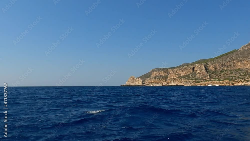 Approaching Levanzo Sicilian island with motorboat cruising fast, Sicily in Italy. Slow-motion low-angle sea level pov Approaching Levanzo Sicilian island with motorboat cruising fast, Sicily in Italy. Slow-motion low-angle sea level pov