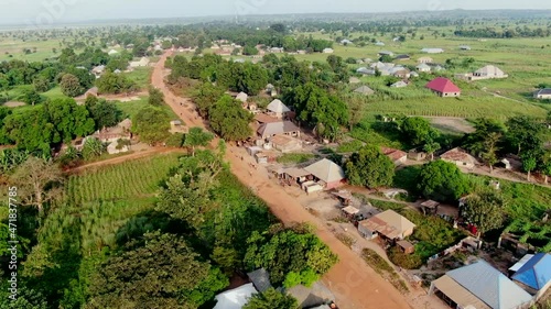 The Nigerian countryside with red dirt roads in the Rukubi farming community - aerial flyover photo