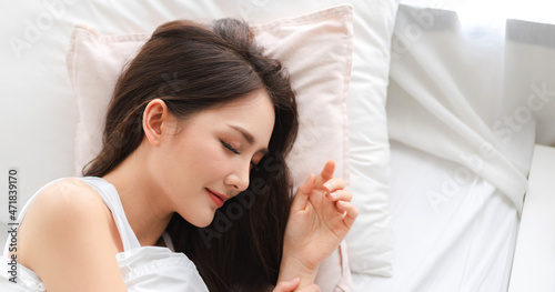 Smiling of cheerful beautiful pretty asian woman clean fresh healthy white skin sleeping and close eye.Girl felling relaxing and enjoy time on the bed at home.asia beauty