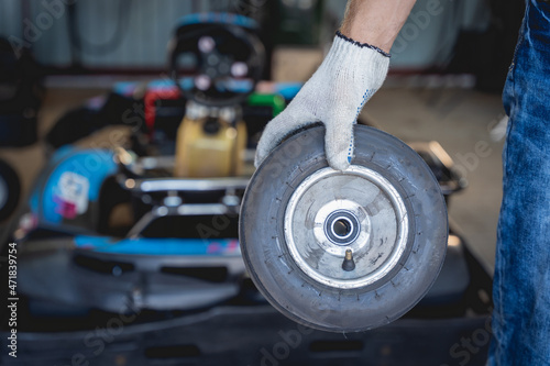 The mechanic go kart racing service change the wheels