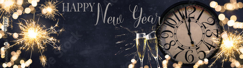 HAPPY NEW YEAR 2022 - Festive silvester New Year's Eve Party celebration background panorama banner long - Golden yellow fireworks, sparklers, clock and champagne classes toasting in the blue night