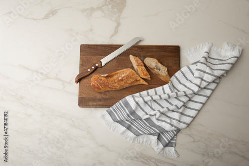 Cutting Board , Bread on a cutting board , freshly baked bread , Sliced baked bread on cutting board , Cutting loaf of bread with knife on cutting board
