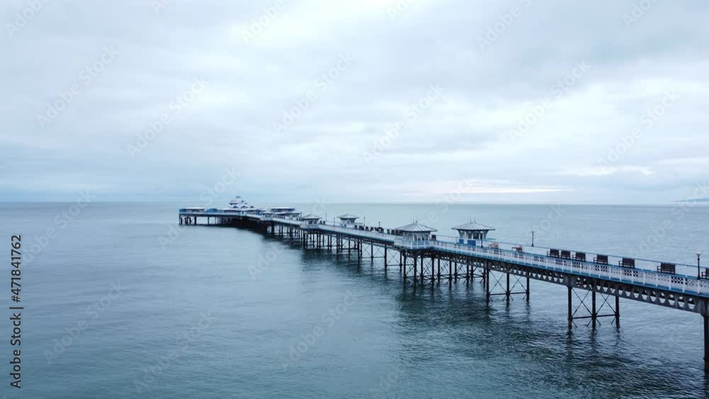 Llandudno pier historic Victorian wooden seaside landmark aerial view low following idyllic boardwalk Llandudno pier historic Victorian wooden seaside landmark aerial view low following idyllic boardwalk