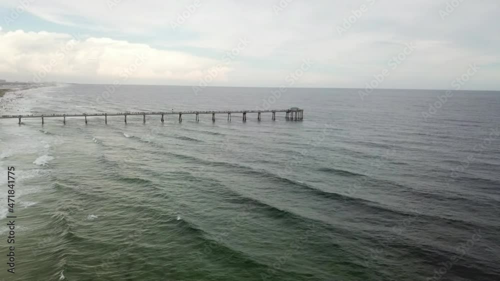 Beach Scenes at Okaloosa Island Fishing and Surfing Pier in Florida, USA On A Cloudy Day - aerial drone shot Beach Scenes at Okaloosa Island Fishing and Surfing Pier in Florida, USA On A Cloudy Day - aerial drone shot