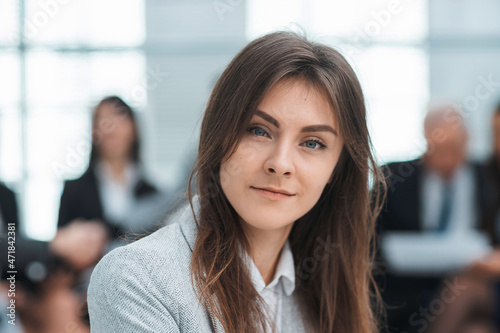 confident young business woman sitting in office