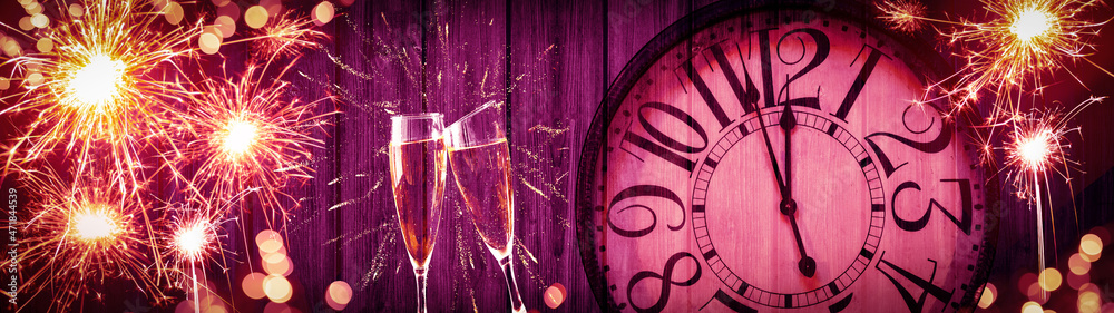HAPPY NEW YEAR 2022 - Festive silvester New Year's Eve Party celebration background panorama banner - Goldenfireworks, sparklers, clock and champagne classes toasting on rustic pink wooden wall