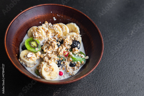 oatmeal fruit breakfast milk, banana, kiwi, berrie, blueberrie meal snack on the table copy space food background