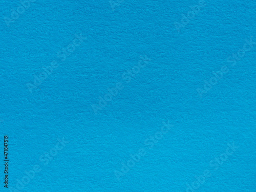 The texture of the paper is azure blue. Textured background made of blue paper. Simple blue background for the design. Blue cardboard. Blue paper texture background