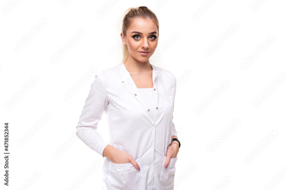 Photo of a beautiful pretty attractive young blonde woman with a ponytail and makeup in a white medical coat of a nurse isolated on a white background with free and copy space for text Photo of a beautiful pretty attractive young blonde woman with a ponytail and makeup in a white medical coat of a nurse isolated on a white background with free and copy space for text