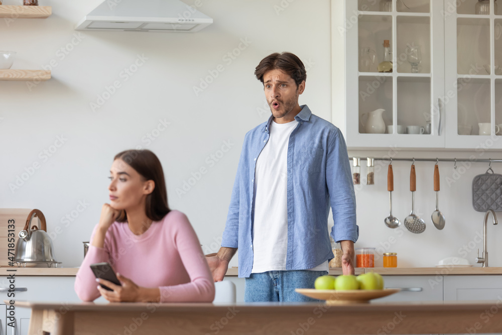 Sad unhappy offended millennial caucasian female surfing in internet in smartphone Sad unhappy offended millennial caucasian female surfing in internet in smartphone