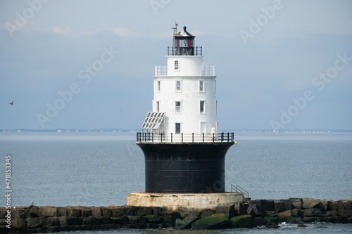 The white and black lighthouse near Cape Henlopen Beach, Lewes, Delaware, U.S.A photo