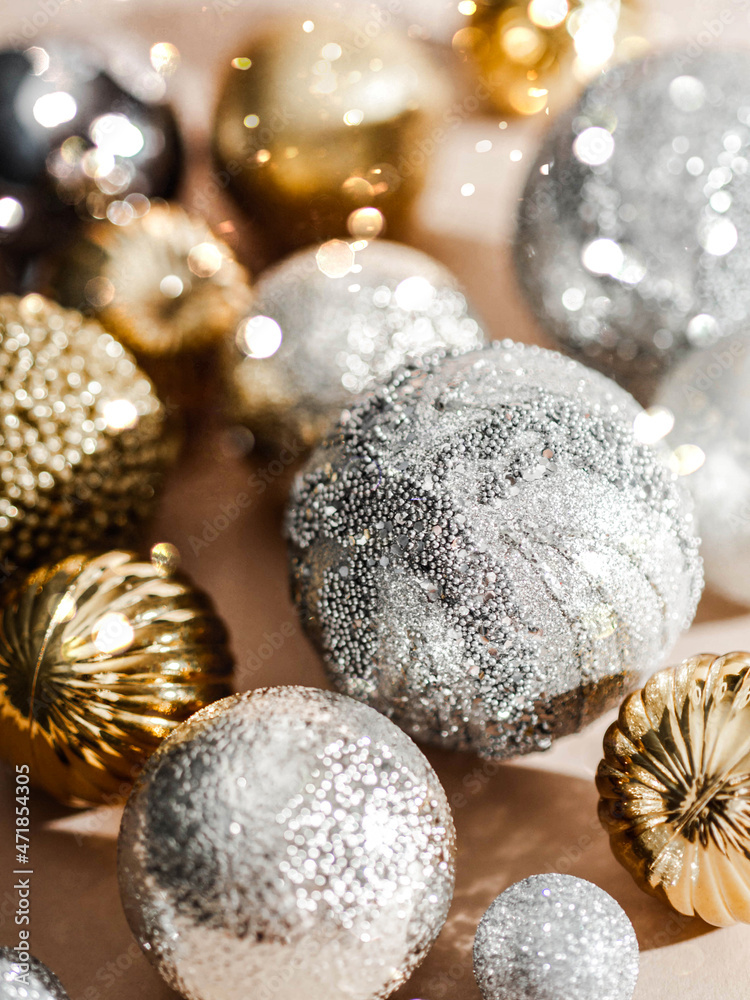 Different Christmas balls background. Gold and silver balls on beige background Different Christmas balls background. Gold and silver balls on beige background