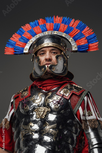 Fototapeta Proud roman centurion warrior with plumed helmet isolated on gray