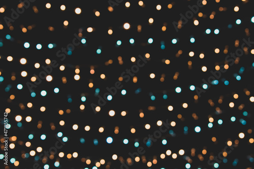Christmas lights. Xmas. Festive New Year blurred blue, golden and black background. Beautiful sparkling backdrop, texture. Bokeh. Copy space. Template. Trendy shades.