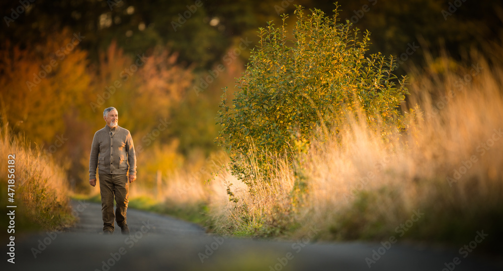 Portrait of handsome senior man in the autumn outdoors. Active senioor enjoying his retirement in the nature Portrait of handsome senior man in the autumn outdoors. Active senioor enjoying his retirement in the nature
