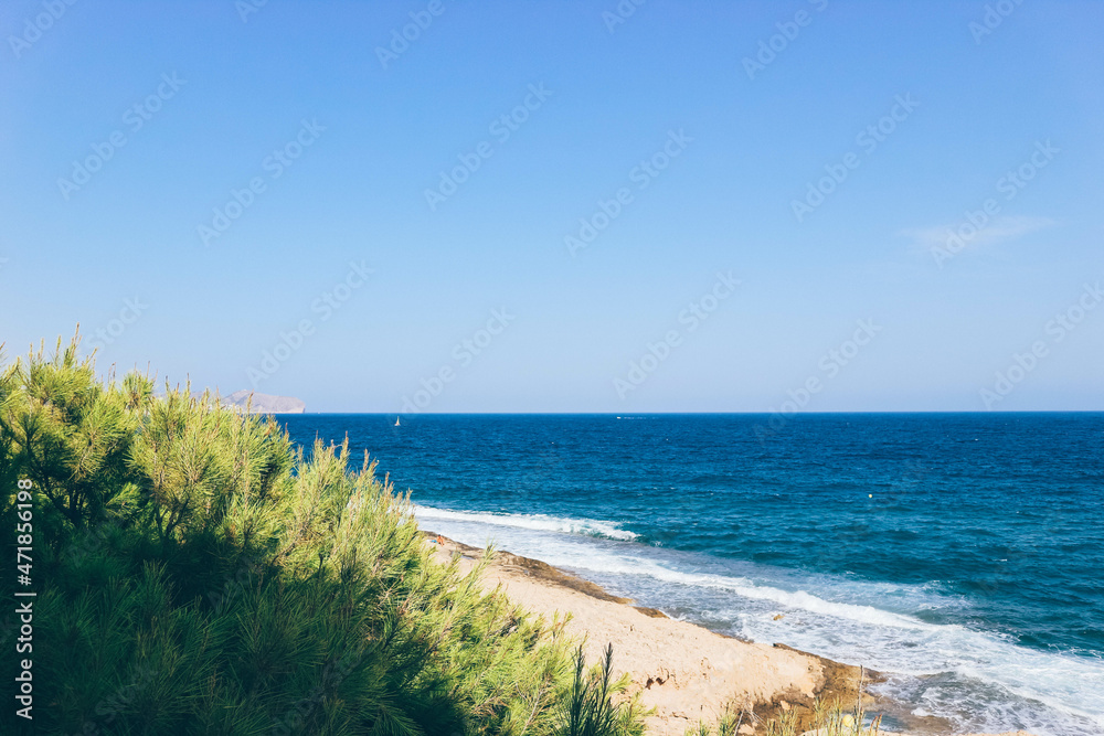 Blue waters over Spanish coast in summer time on clear sky