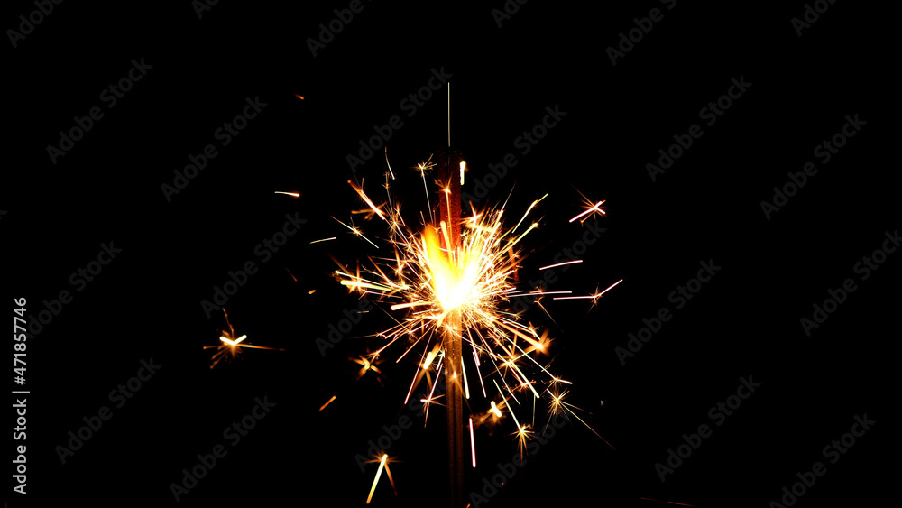 Burning sparkler isolated on black background. Festive Sparkler. Celebration, Success, New Years Concept