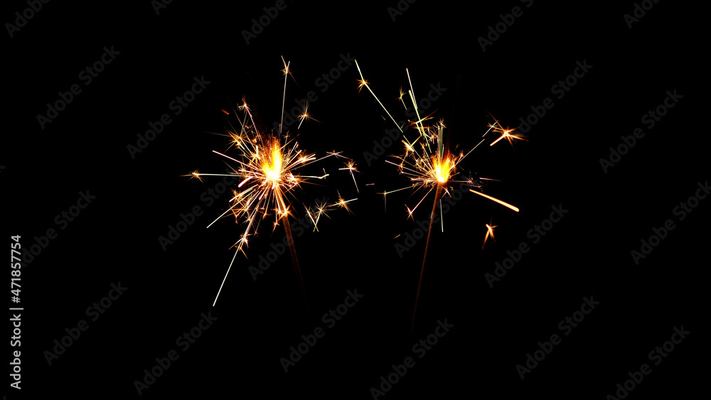 Burning sparklers on black background. Burning New Year sparklers