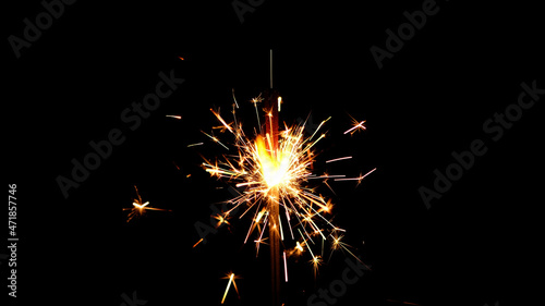 Burning sparkler isolated on black background. Festive Sparkler. Celebration  Success  New Years Concept