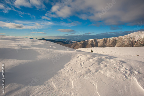 Panorama of snow-capped mountains, snow and clouds on the horizon